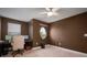 Inviting bedroom boasts a unique window, ceiling fan, and plush carpeting for a cozy atmosphere at 11550 Lake Lucaya Dr, Riverview, FL 33579