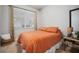 Cozy bedroom with orange bedding, a plush rug, and decorative table at 11550 Lake Lucaya Dr, Riverview, FL 33579