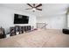 Upper-level bonus room featuring a large TV, storage and carpet floors, perfect for Gathering entertainment at 11550 Lake Lucaya Dr, Riverview, FL 33579