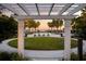 Common green space with chairs and pergola overlooking the resort-style community pool at 11550 Lake Lucaya Dr, Riverview, FL 33579