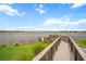 Inviting wooden dock and walkway offering picturesque views of the serene lake, ideal for leisurely strolls and enjoying nature at 11550 Lake Lucaya Dr, Riverview, FL 33579