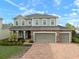 Charming two-story home featuring a three-car garage and beautiful brick driveway at 11550 Lake Lucaya Dr, Riverview, FL 33579