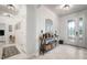 Bright foyer featuring stylish console table, modern mirror, and decorative baskets at 11550 Lake Lucaya Dr, Riverview, FL 33579