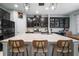 Modern kitchen with dark cabinetry, pendant lighting, granite countertops, and an expansive center island at 11550 Lake Lucaya Dr, Riverview, FL 33579