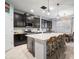 Modern kitchen featuring a spacious island with seating, granite countertops, and stainless steel appliances at 11550 Lake Lucaya Dr, Riverview, FL 33579