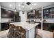Gourmet kitchen featuring a large center island, granite countertops, and dark cabinetry with stainless appliances at 11550 Lake Lucaya Dr, Riverview, FL 33579