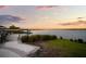 Scenic lakeside view with a sandy beach area, perfect for relaxing and enjoying the sunset at 11550 Lake Lucaya Dr, Riverview, FL 33579