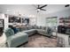 Open concept living area featuring a large sectional couch, kitchen, dining area, and access to the backyard at 11550 Lake Lucaya Dr, Riverview, FL 33579