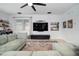 Living room featuring a large TV, comfortable seating, and a stylish wet bar for entertaining guests at 11550 Lake Lucaya Dr, Riverview, FL 33579