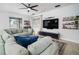 Inviting living room with a large sectional, view to the backyard, wet bar, and modern decor at 11550 Lake Lucaya Dr, Riverview, FL 33579