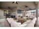 Inviting outdoor living area featuring comfortable seating, a TV, ceiling fans, and a built-in BBQ for outdoor entertaining at 11550 Lake Lucaya Dr, Riverview, FL 33579