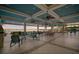 Spacious outdoor lounge area with comfortable seating overlooking a serene lake view at sunset at 11550 Lake Lucaya Dr, Riverview, FL 33579