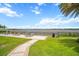 Outdoor seating area with lawn, tables, chairs and a lake view for relaxation and social gatherings at 11550 Lake Lucaya Dr, Riverview, FL 33579