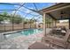 Enclosed pool area with ample lounging space, covered seating, and a manicured lawn at 11550 Lake Lucaya Dr, Riverview, FL 33579