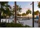 Community pool area with various seating options, surrounded by lush greenery and palm trees at 11550 Lake Lucaya Dr, Riverview, FL 33579