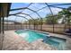 Stunning pool area with a screened enclosure, sun loungers and a tropical landscape at 11550 Lake Lucaya Dr, Riverview, FL 33579