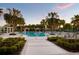 Resort-style pool area featuring lounge chairs, cabanas, lush landscaping, and palm trees at 11550 Lake Lucaya Dr, Riverview, FL 33579