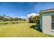 Expansive backyard with mature trees and a pond view, providing a peaceful outdoor retreat at 11567 Weston Course Loop, Riverview, FL 33579