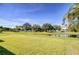 Lush green backyard offers a serene water view, mature trees, and ample space for outdoor activities at 11567 Weston Course Loop, Riverview, FL 33579