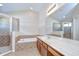 Bathroom showcasing a large soaking tub, vanity with sink, and glass-enclosed shower at 11567 Weston Course Loop, Riverview, FL 33579