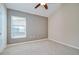Bedroom featuring a high ceiling, neutral carpet, and large window for natural light at 11567 Weston Course Loop, Riverview, FL 33579