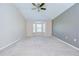 Carpeted bedroom features a ceiling fan, a bay window, and two-tone neutral walls at 11567 Weston Course Loop, Riverview, FL 33579