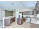 Stylish kitchen showcasing stainless steel appliances, granite countertops, a center island, and tile floors at 11567 Weston Course Loop, Riverview, FL 33579