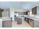 Beautiful kitchen featuring stainless steel appliances, granite countertops, dark wood cabinets, and tile flooring at 11567 Weston Course Loop, Riverview, FL 33579