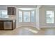 Bright kitchen features a stainless steel dishwasher, tile flooring, and granite countertops at 11567 Weston Course Loop, Riverview, FL 33579