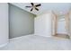 Spacious living room featuring plush carpeting, neutral walls, modern fan, and ample natural light at 11567 Weston Course Loop, Riverview, FL 33579