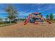 Community playground with slides, climbing structures, and a cushioned ground surface for safety at 11567 Weston Course Loop, Riverview, FL 33579
