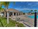 Community pool with ample seating, a covered lounge area, and lush landscaping at 11567 Weston Course Loop, Riverview, FL 33579