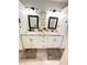 Bathroom features double vanity with granite countertops, framed mirrors, and tile flooring at 1233 Belleair Rd, Clearwater, FL 33756