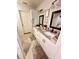 This bathroom features granite countertops, framed mirrors, double sinks, and tile flooring at 1233 Belleair Rd, Clearwater, FL 33756