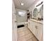 Bathroom with walk-in shower, double vanity with granite countertops and decorative mirrors at 1233 Belleair Rd, Clearwater, FL 33756