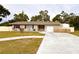 Single-story home features a well-maintained yard, a front-facing garage, and a concrete driveway at 1233 Belleair Rd, Clearwater, FL 33756