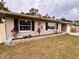 Charming home with fresh landscaping, flower beds and attractive exterior features at 1233 Belleair Rd, Clearwater, FL 33756