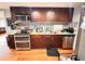Well-equipped kitchen featuring stainless steel appliances, granite countertops, and dark wood cabinetry at 1233 Belleair Rd, Clearwater, FL 33756