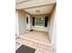 Welcoming front porch with tiled flooring, a storm door, and an exterior light fixture at 1233 Belleair Rd, Clearwater, FL 33756