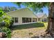 Backyard with a screened patio and lush landscaping, a perfect retreat with an additional building at 13409 Fawn Springs Dr, Tampa, FL 33626