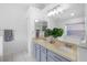 Bathroom with double sink vanity, quartz countertop, and a large mirror, offering a bright and airy feel at 13409 Fawn Springs Dr, Tampa, FL 33626