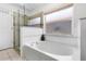 Elegant bathroom featuring a soaking tub, walk-in shower, and decorative elements, creating a spa-like retreat at 13409 Fawn Springs Dr, Tampa, FL 33626