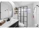 Modern bathroom with sleek black fixtures, open shelving and a glass enclosed shower at 13409 Fawn Springs Dr, Tampa, FL 33626