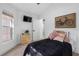 Cozy bedroom with TV, wood-look floors and natural light from the window at 13409 Fawn Springs Dr, Tampa, FL 33626