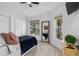 Inviting bedroom featuring two large windows, wood-look tile floors and a large mirror at 13409 Fawn Springs Dr, Tampa, FL 33626
