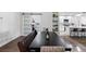 Dining room with bench seating, dark wood table and sliding barn door entrance to office at 13409 Fawn Springs Dr, Tampa, FL 33626