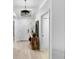 Bright entryway with a decorative light fixture and a stylish wooden console table at 13409 Fawn Springs Dr, Tampa, FL 33626