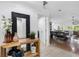 Bright entryway with rustic wood table, decorative mirror, and open view to the spacious living area at 13409 Fawn Springs Dr, Tampa, FL 33626