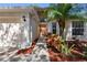 Charming front entrance with a well-maintained lawn and landscaping, complemented by an inviting doorway at 13409 Fawn Springs Dr, Tampa, FL 33626