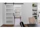 Hallway with sliding barn door access to an office at 13409 Fawn Springs Dr, Tampa, FL 33626